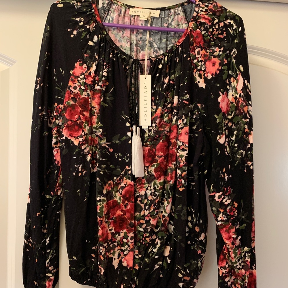 New never worn Love Stitch blouse. Black with red and pink flowers. Tie front.